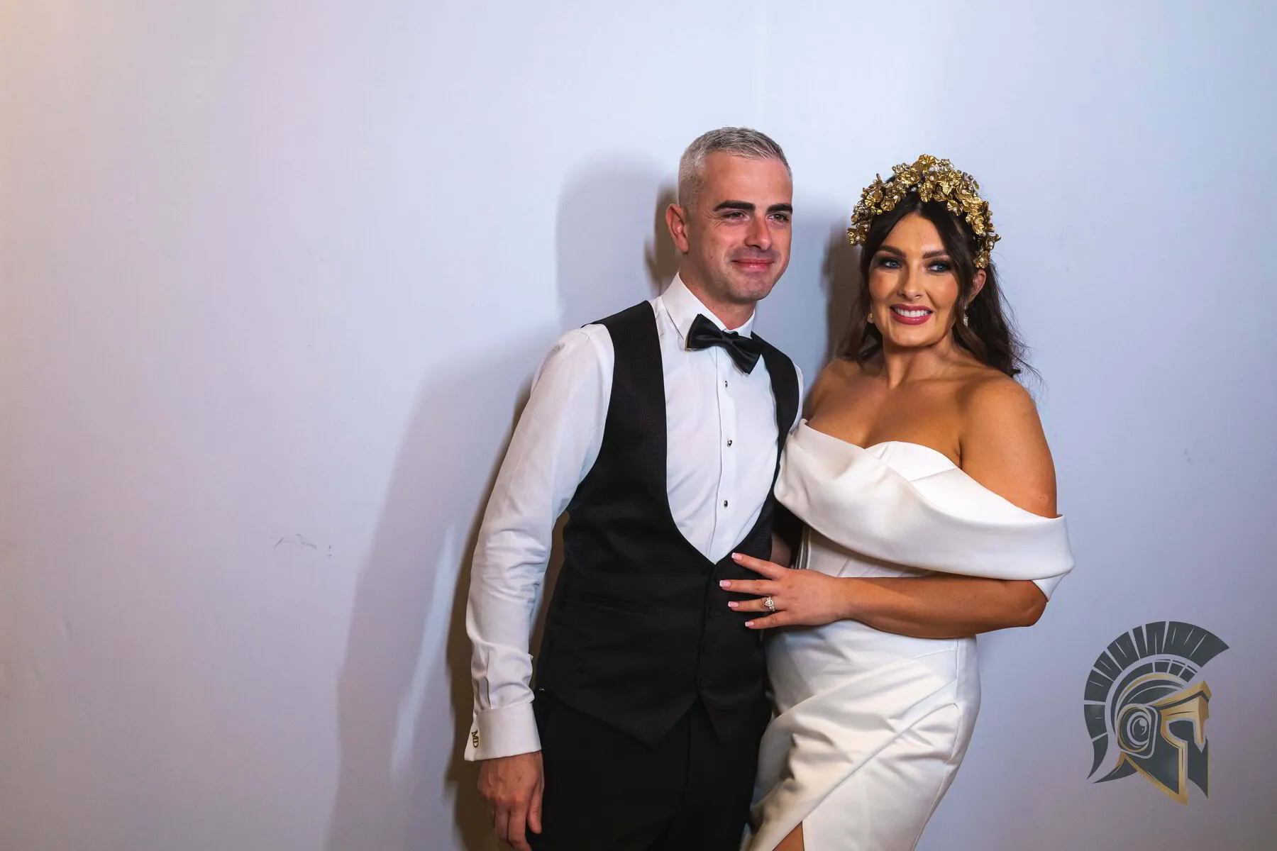 Elegant wedding photo booth setup with floral arch and studio ring lighting